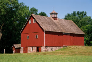The Swensson Farm Museum. An old barn with stone base and bright red siding. 